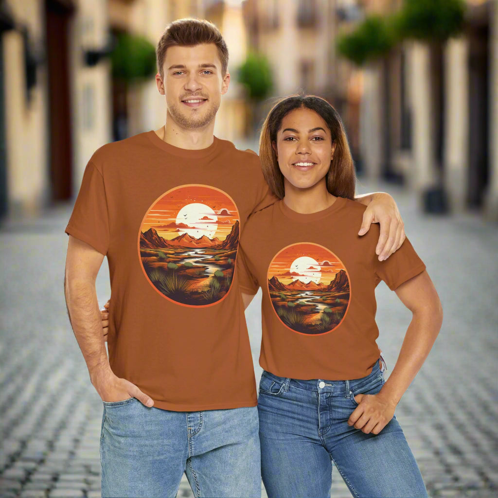 A man and a woman standing next to each other, both wearing brown crew neck t-shirts with a sunset design and text 'Sunset' on the front.